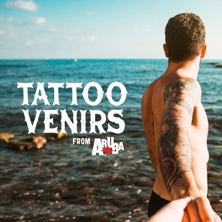 A shirtless man with a detailed arm tattoo stands by the ocean, holding someone's hand. The text "Tattoovenirs from Aruba" overlays the image.